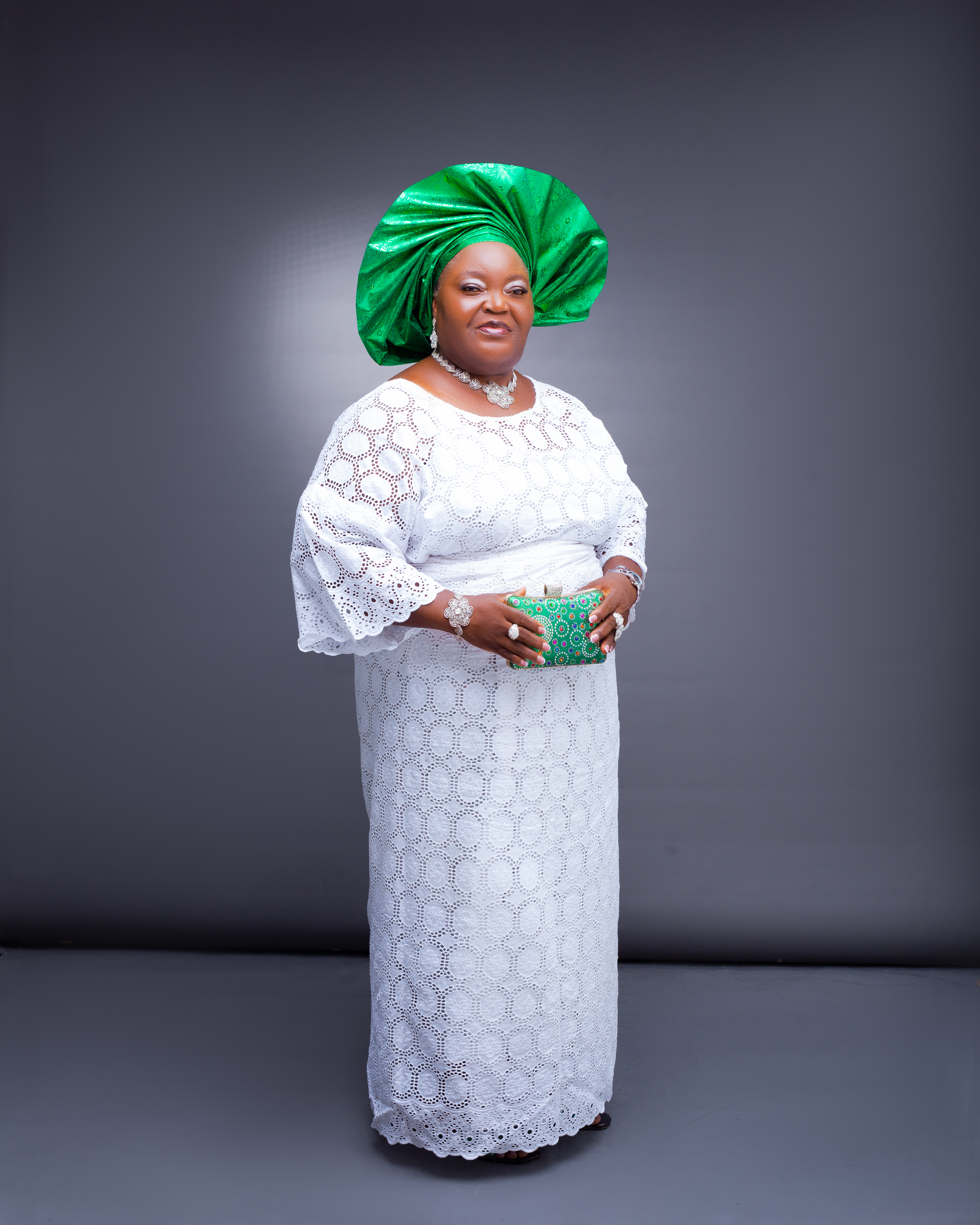 Mrs. Catherine standing in elegant white lace outfit